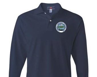 May include: A navy blue long-sleeve polo shirt with a Community Emergency Response Team (CERT) logo embroidered on the left chest. The logo features a blue and white American flag, the words "Community Emergency Response Team", and the acronym "CERT" in green.