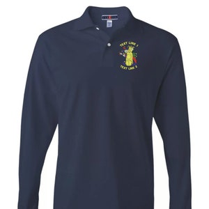 May include: A navy blue long-sleeve polo shirt with an embroidered design of a cartoon figure with the text "TEXT LINE 1" and "TEXT LINE 2" on the left chest.