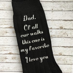May include: Black socks with white text that reads "Dad. Of all our walks this one is my favorite I love you".