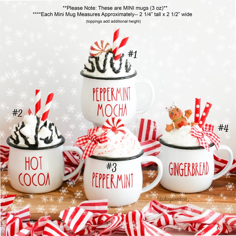 May include: Four mini white mugs with black rims, each decorated with a different holiday-themed design and topping. The mugs are labeled #1 Peppermint Mocha, #2 Hot Cocoa, #3 Peppermint, and #4 Gingerbread. Each mug measures approximately 2 1/4 inches tall by 2 1/2 inches wide.