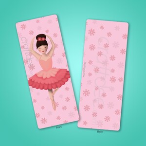 May include: Pink bookmark with a ballerina in a pink and red tutu on the front. The back of the bookmark has a pink snowflake pattern and the text "craftdee.com".