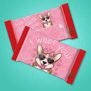 Puede incluir: Un envoltorio de barra de chocolate rosa y rojo con un corgi de dibujos animados que lleva gafas de sol y un lazo. El envoltorio tiene el texto "You Are Paw-tastic" y "I woof you!" impreso en él.