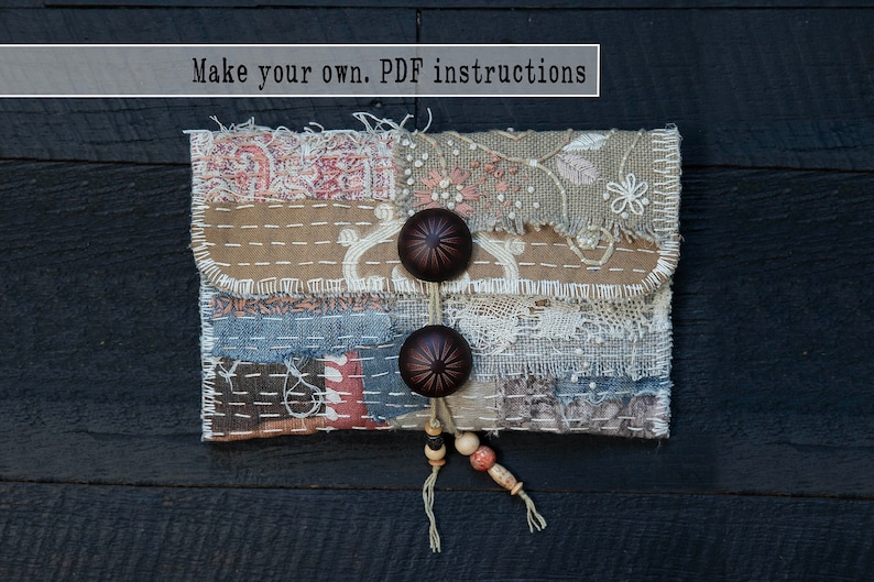 May include: A handmade fabric pouch with a patchwork design, featuring different textures and colors. The pouch has a flap closure with two brown buttons and a tassel with wooden beads.