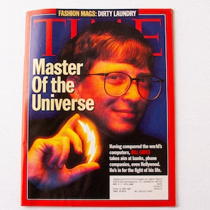 May include: A red TIME magazine cover featuring Bill Gates, the founder of Microsoft, with the headline "Master of the Universe". The cover image shows Gates holding a glowing lightning bolt in his hand.