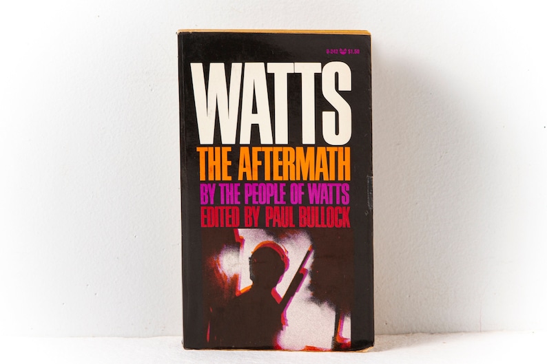 May include: A black book titled "Watts: The Aftermath" by the people of Watts, edited by Paul Bullock. The cover features a silhouette of a person holding a rifle in front of a fiery background.