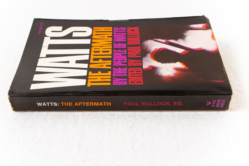 May include: A black book with the title "Watts: The Aftermath" by the people of Watts, edited by Paul Bullock. The book cover features a silhouette of a person against a red and white background.
