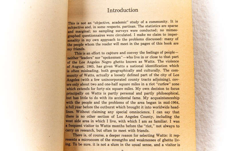 May include: A page from a book titled "Introduction" discussing the social and cultural aspects of the Watts neighborhood in Los Angeles, California. The text describes the area as a "loosely defined part of the city" and mentions the 1965 riots.