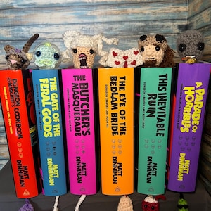 Crocheted Dungeon Crawler Carl inspired bookmarks keychains Princess Donut Zev Quasar Louis Rend Samantha Prepotente