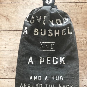 Kitchen towel holder with linen towel. Bushel and a peck