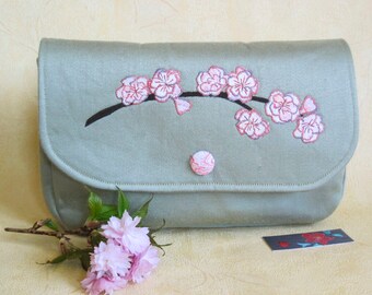 Pale green clutch bag with cherry blossom applique design