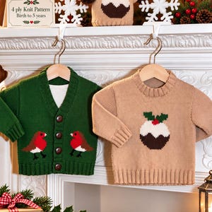 May include: A dark green knit cardigan with two robin bird motifs and a tan knit sweater with a Christmas pudding motif. A sign reads 4 ply Knit Pattern Birth to 5 years. Both garments hang on wooden hangers from a white mantelpiece.