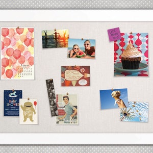 May include: A corkboard with a white frame and a beige fabric surface. The corkboard is decorated with various photos, cards, and notes. There are photos of people at the beach, a cupcake, a baby shower invitation, and a birthday card. There is also a calendar with red balloons and a note that says "Let's make this!"