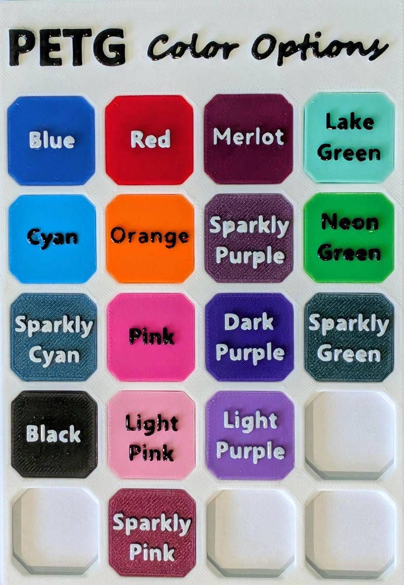 May include: A white PETG color options chart featuring a grid of square samples with rounded corners. Each sample is labeled with text including Blue, Red, Merlot, Lake Green, Cyan, Orange, Sparkly Purple, Neon Green, Sparkly Cyan, Pink, Dark Purple, Sparkly Green, Black, Light Pink, Light Purple, and Sparkly Pink.