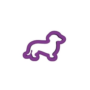 May include: A purple and white dachshund dog-shaped cookie cutter. The cookie cutter is a silhouette of the dog, with a white interior and a purple outline. The dog is in a standing position.