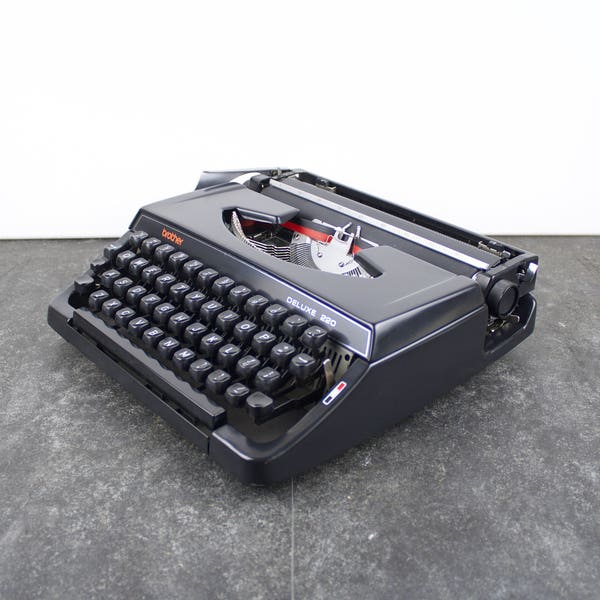 Vintage Red Brother Deluxe 220 typewriter in working condition