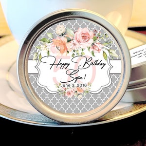 May include: A round silver tin with a floral design and the text "Happy 50th Birthday Sofia! June 3, 2016".