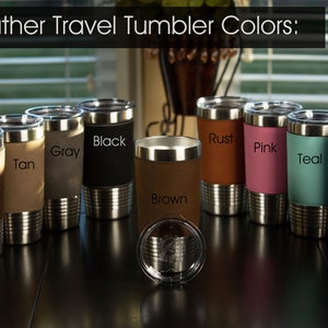 May include: Leather travel tumblers in various colors, including rustic, tan, gray, black, brown, rust, pink, teal, and blue. The tumblers have a stainless steel exterior and a leather-like wrap.