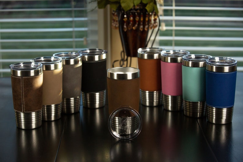 May include: A set of ten stainless steel tumblers with a variety of colored faux leather wraps. The tumblers have a double-wall construction and are insulated to keep drinks cold or hot.