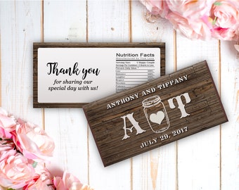 May include: A rustic wooden wedding favor box with a white label that says "Thank you for sharing our special day with us!" and a brown label with the text "Nutrition Facts" and "Manufactured by True Love". The box also has a brown label with the text "Anthony and Tiffany" and "A&T" with a mason jar and heart graphic. The date "July 29, 2017" is printed on the box.
