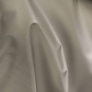 May include: A close-up of a smooth, white fabric with soft folds and wrinkles. The fabric has a subtle sheen and a luxurious feel.