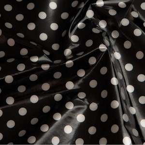 Tissu vinyle noir à pois