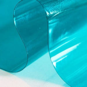 May include: A sheet of translucent turquoise blue plastic with a rippled texture.