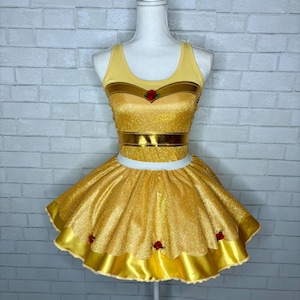 May include: A yellow and gold glitter dress with a satin trim and red rose accents. The dress has a sleeveless top with a gold bodice and a full skirt.