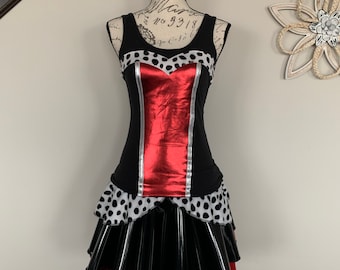 May include: A black and red dress with a white polka dot pattern. The dress has a red bodice with a silver trim and a black skirt with a red ruffle.