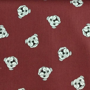 May include: Burgundy fabric with a repeating pattern of white bulldog faces. The bulldogs have black accents and are evenly spaced across the surface. The fabric has a smooth texture and a consistent color.