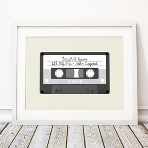 May include: A gray cassette tape with the text "Sarah & Lewis" and "All Of Me - John Legend" on the label. The date "11-08-16" is printed below the song title.