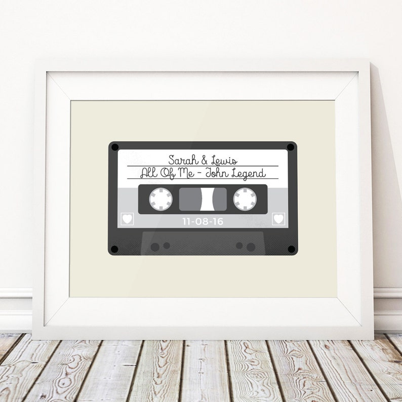 May include: A gray cassette tape with the text "Sarah & Lewis" and "All Of Me - John Legend" on the label. The date "11-08-16" is printed below the song title.