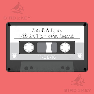 May include: A gray cassette tape with a white label. The label has the text "Sarah & Lewis" and "All Of Me - John Legend". The date "11-08-16" is printed below the song title.