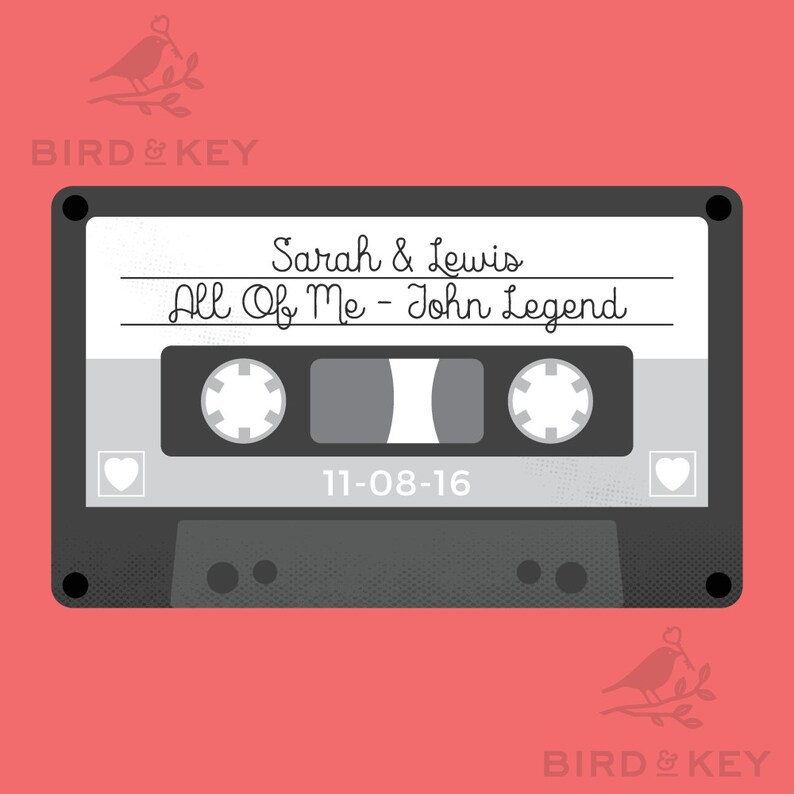 May include: A gray cassette tape with a white label. The label has the text "Sarah & Lewis" and "All Of Me - John Legend". The date "11-08-16" is printed below the song title.