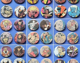 May include: A collection of 36 round, colorful buttons featuring various comic book characters. The buttons are arranged in a grid pattern and feature a variety of characters, including superheroes, villains, and other fictional figures.