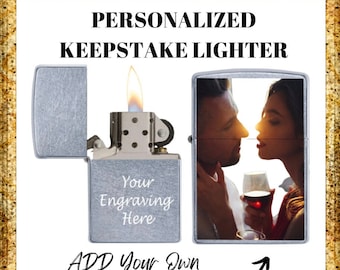 May include: Silver lighter with a personalized engraving space and a photo insert. The lighter has a flame coming out of the top. The text on the lighter says "Your Engraving Here".