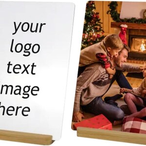 May include: Two rectangular photo displays with wooden bases. One features the text "your logo text image here." The other shows a family gathered in front of a fireplace, with a Christmas tree in the background. The displays are designed for photos.