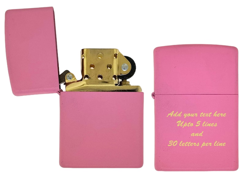 May include: A pink lighter with a gold hinge and a gold top. The lighter has a blank space on the front for personalization. The text on the lighter reads "Add your text here Upto 5 lines and 30 letters per line".