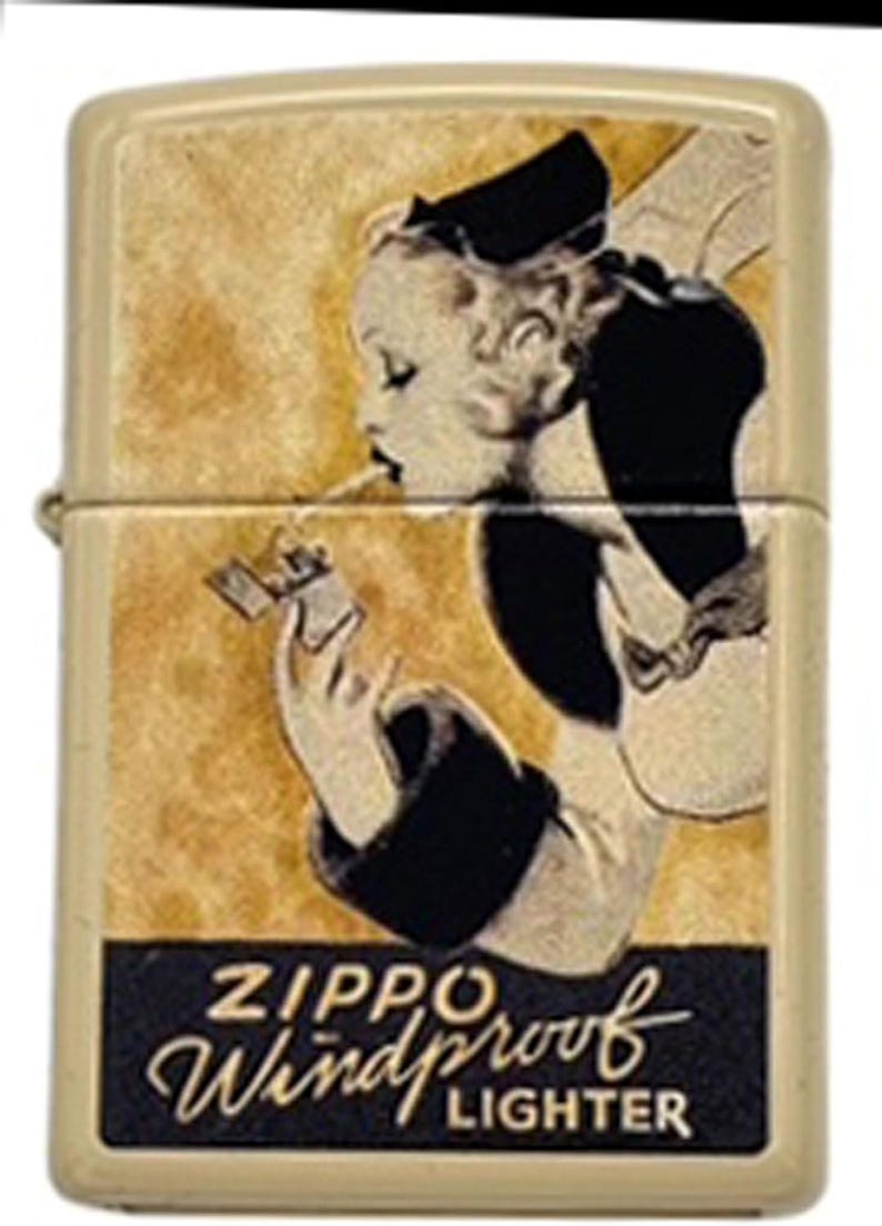 May include: A vintage Zippo Windproof Lighter with a cream-colored case. The lighter features a retro illustration of a woman lighting a cigarette. The Zippo logo and "Windproof Lighter" text are displayed in a black rectangle.