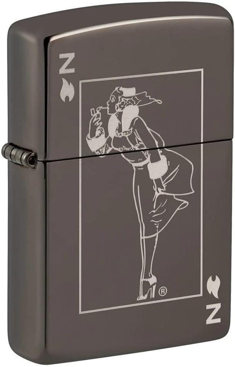 May include: Gunmetal-colored lighter with a detailed engraved design. The design features a woman in a vintage outfit, smoking a cigarette. The lighter has the letter "N" and a flame symbol on the sides.