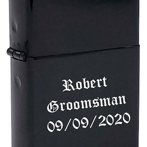 May include: Black lighter with the text "Robert Groomman 09/09/2020" engraved in white.