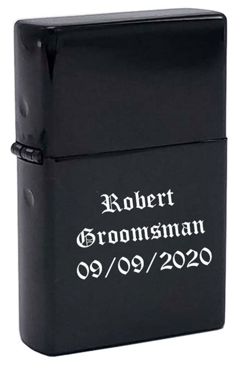 May include: Black lighter with the text "Robert Groomman 09/09/2020" engraved in white.
