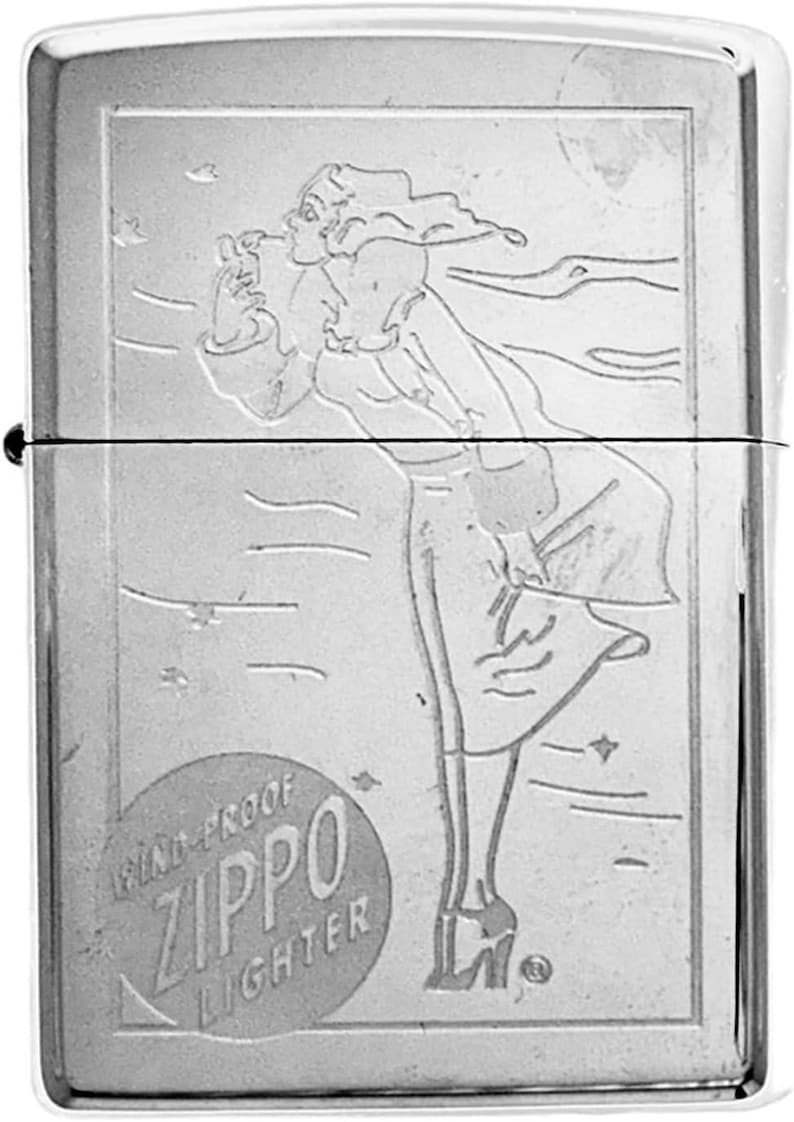 May include: A silver Zippo lighter with an engraved design of a woman in a flowing dress, smoking a cigarette. The lighter has the words "Wind-Proof Zippo Lighter" in a circular emblem.
