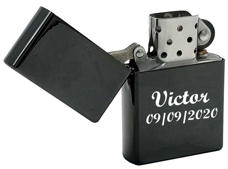May include: Black lighter with a silver top and a personalized inscription that reads "Victor 09/09/2020".