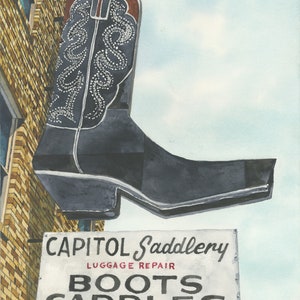 May include: A vintage sign for Capitol Saddlery, featuring a large, black cowboy boot with white stitching and a white sign that reads "Luggage Repair Boots Saddles".