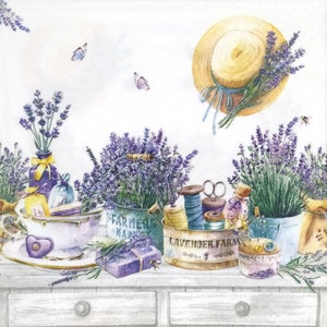 May include: A watercolour illustration featuring a straw hat with lavender, a teacup, a Farmers Market bucket, and a Lavender Farm container filled with sewing supplies, lavender sprigs, and butterflies on a white surface with two drawers.