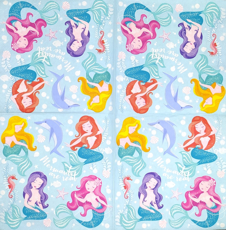 May include: A blue and white patterned fabric with a repeating design of mermaids, dolphins, and seashells. The text "Mermaids are real" is repeated throughout the fabric.