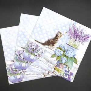 May include: Three white paper napkins with a floral and cat design. The napkins feature a cat looking at a bee, lavender flowers in a pot labeled "Flowers", and purple flowers in pots.