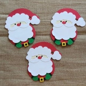 May include: Three red and white paper Santa Claus ornaments with white beards and green belts. The ornaments are cut out and have a flat back.
