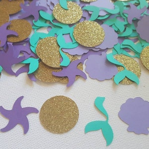 May include: Purple and teal mermaid-themed confetti with gold glitter circles. The confetti includes starfish, seashells, and mermaid tails.