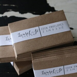 May include: A stack of brown paper coin envelopes with a white label that reads "Laurel St. Design" and "Coin Envelopes 2 1/4 x 3 1/2"